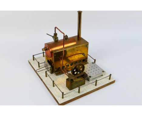 Unmarked Maker - An unmarked but very well engineered copper and brasss stationary steam engine. The engine is mounted on a F