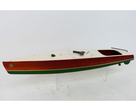 Kellner - A vintage Keller wooden clockwork speedboat. The boat with partially painted hull in green with cream stripe and cr