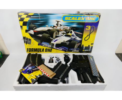Scalextric - A boxed Scalextric 'Formula One' set. Set includes a quantity of track, controllers and accessories plus a Willi
