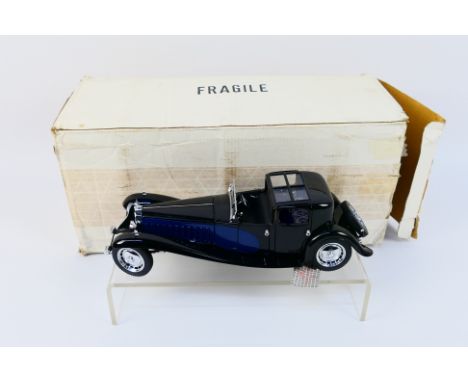 Franklin Mint - Precision Models. A boxed "1930 Bugatti Royal Coup Napoleon" appearing in good condition - with some signs of