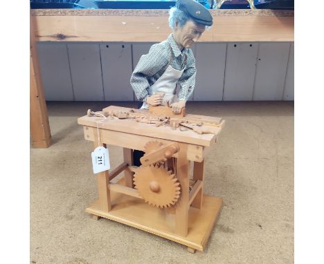 A large carved wood automaton figure of a carpenter made by Eric Williamson, numbered 242, 16" high
