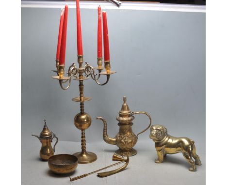 A collection of vintage 20th century brass wares to include a large brass bulldog, brass candelabra, Moroccan brass dallahs, 
