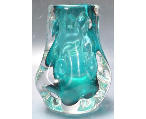 A retro vintage 1970's 20th century studio art glass Liskeard green cased glass " Knobbly " vase. Designed by Jim Dyer. Measu