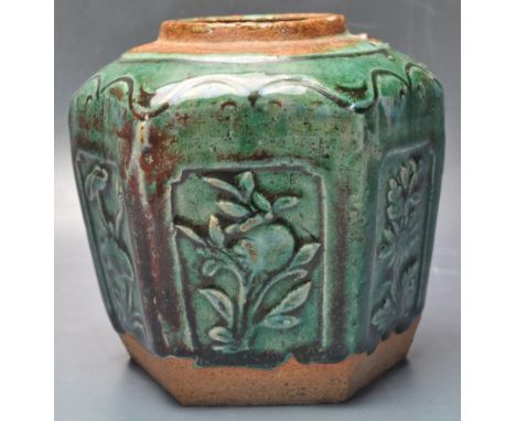 A 19th century Chinese oriental ceramic ginger jar. The jar of a hexagonal form with raised local motifs finished in green po