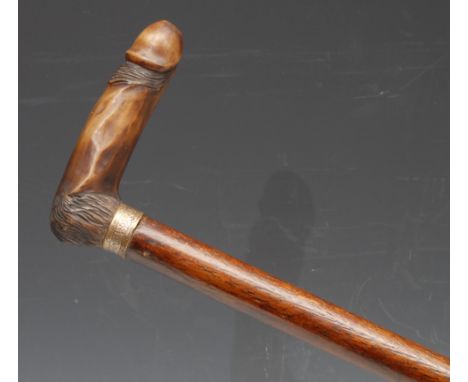 Erotica - a novelty walking stick, the bone handle carved as a phallus, hardwood cane, 76cm long 