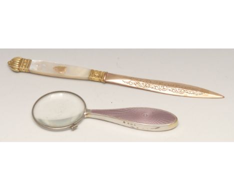 A 19th century gilt metal and mother of pearl letter knife, 21.5cm long; a silver and guilloche enamel hand lens, 14cm long, 