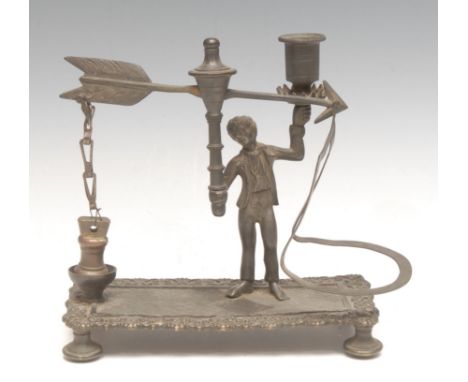 An unusual Regency dark patinated bronze figural combination letter balance and desk top taper stick, shaped rectanhgular bas