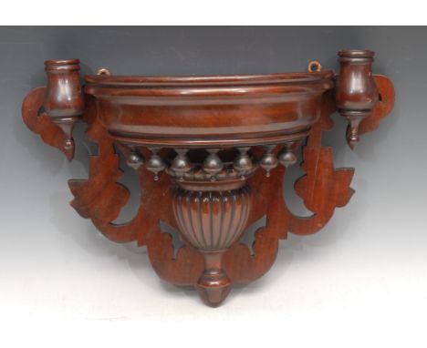 An Edwardian mahogany wall bracket, turned and gadrooned central carving flanked by a pair of candle holders, on a pierced ba