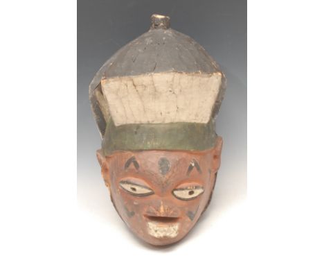 Tribal Art - a Yoruba gelede helmet mask, decorated in red, black and white pigments, 23cm high, Nigeria 