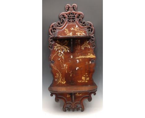 A Chinese hardwood wall shelf, shaped and pierced cresting above two folding tiers, decorated in gilt and applied with mother