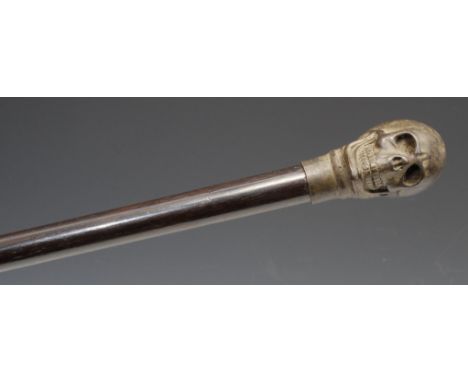 The Macabre - a novelty walking stick, the verdigris patinated bronze pommel as a memento mori skull, hardwood cane, 86cm lon