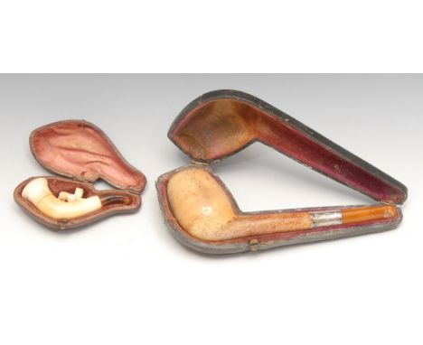 A German silver coloured metal mounted meerschaum pipe, 16cm long, c.1900, cased; a cheroot holder, carved with a dog, 8cm lo