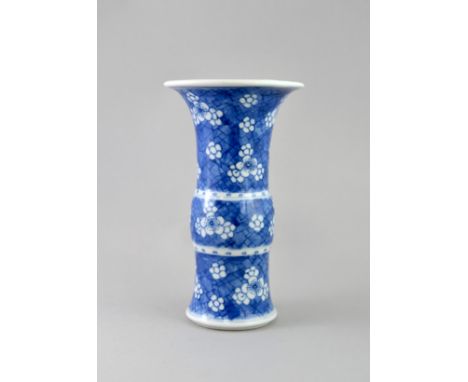 A Blue and White Beaker Vase with Prunus, Kangxi period, , painted in soft tones with prunus on a blue ground cracked ice fie