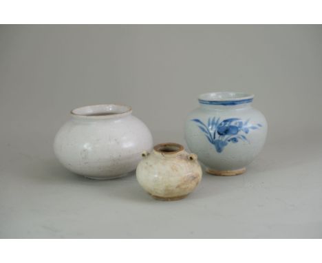 Three Korean Ovoid Jars, Joseon period, the bigger white jar of ovoid shape with splayed mouth,  covered with a creamy white 