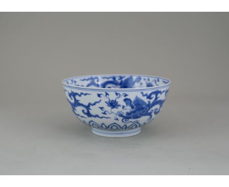 An Attractive Blue and White Dragon Bowl, Kangxi, crisply painted with dragons, the interior painted with vishva-vajra in the