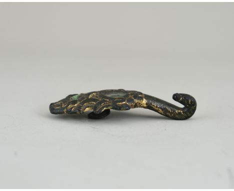 A Gilt Bronze Belthook, Han dynasty, with dragon head hook, the body  moulded with scrollwork enclosing inlaid turquoise bead