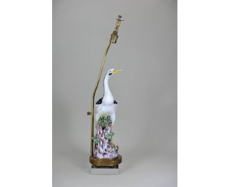 A 'famille rose' Crane, Qianlong, the elegant slender bird seated on rockwork, with neck and tail enamelled black and green, 