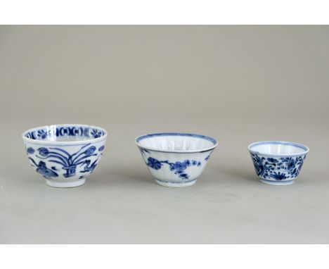Three Blue and White Teacups, Kangxi, comprising two fluted cups, one with geese and the other with flower sprays, and a smal