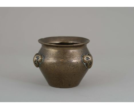 A Silver inlaid Bronze Waterpot, 17th century, in the form of a miniature fishbowl, with three moulded rams head handles on t