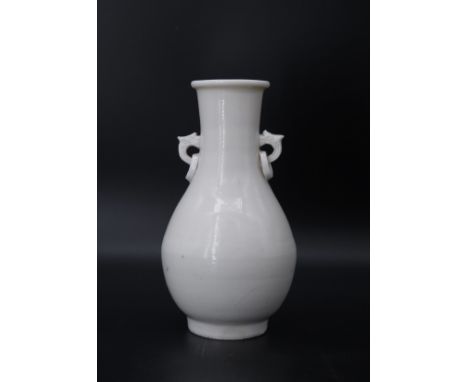 A Good  Dehua Vase, Kangxi, of slender bottle form, the slightly waisted neck with double loop phoenix head handles with susp