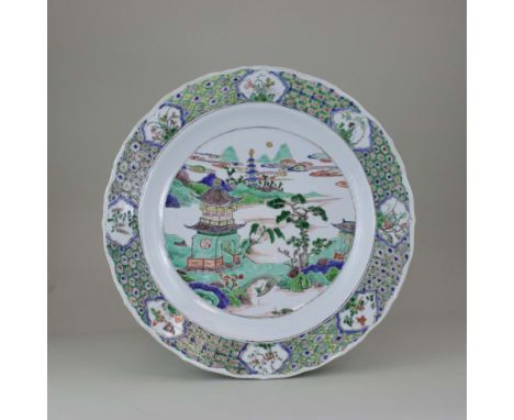 A 'famille verte' Landscape Dish, Kangxi, richly enamelled, with a central moonlit lake landscape where a lone boatman poles 