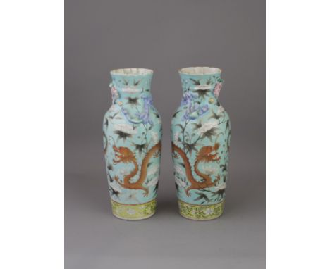 A Pair of Turquoise ground Dragon Vases, late Qing dynasty, each with a red and gilt dragon following a gilt and en grisaille