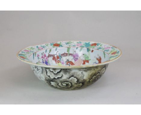 A 'famille rose' Basin, 19th century, with a central medallion of a lady dancer and musicians, the well with boys in gardens 