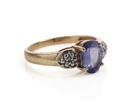 A tanzanite and diamond dress ring, the faceted oval tanzanite on diamond set shoulders, in 18ct gold, size N 1/2, 3.3g gross
