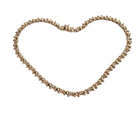A gold elephant pattern necklace, formed of a line of elephant form links standing tusk to tail, stamped "750" to clasp, 42cm