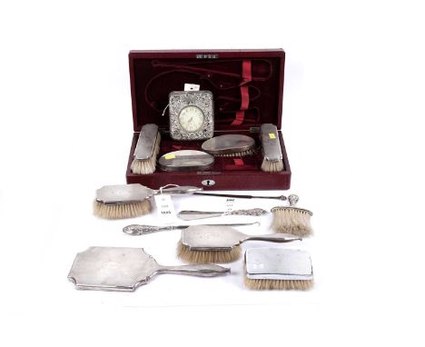 A selection of silver mounted dressing table items, to include: clothes brushes, hairbrushes, a hand mirror, and a Goliath tr