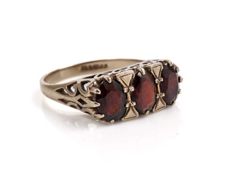 A garnet three stone ring, in 9ct yellow gold, size Q, 3.7g gross.