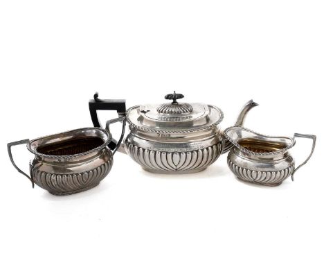 A late Victorian silver three-piece tea service, by William Aitken, Chester 1899, the teapot with presentation inscription, 1