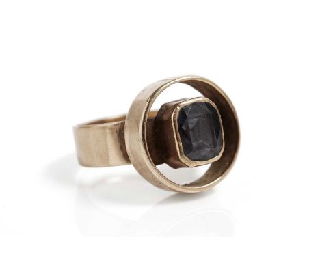 A blue spinel single stone ring, the faceted collet set spinel within a circular border, in 9ct yellow gold, size M 1/2, 6.5g