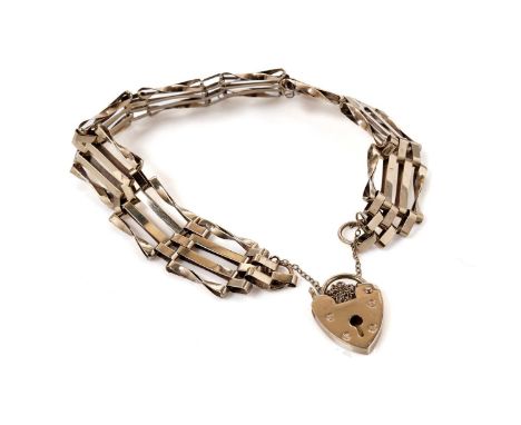 A 9ct yellow gold gate link bracelet, with heart-shaped padlock clasp and safety chain, approximately 17cms long, 8.7g gross.