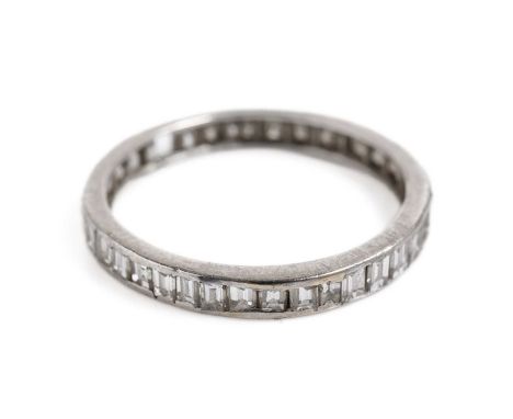 A diamond eternity ring, the channel set princess cut diamonds set in white gold, unmarked, surface tests as approximately 14
