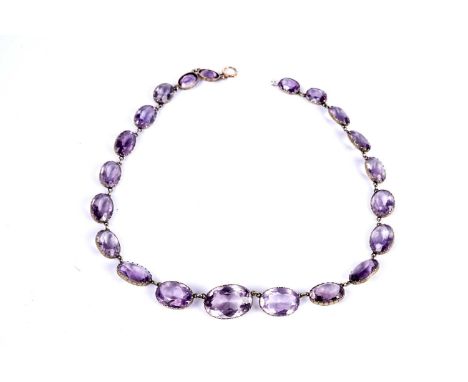A Victorian amethyst Riviera necklace, the graduated oval facet cut amethyst tapering from 21.0mm by 14.6mm, depth 10.3mm to 