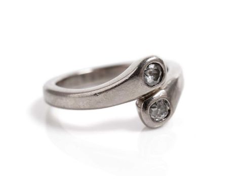 A contemporary diamond two stone ring, the old-cut diamonds in 18ct white gold crossover setting, size P 1/2, 8.7g gross.