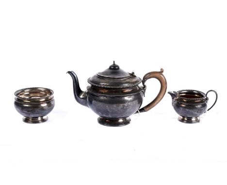 A George V three-piece silver tea service, by Adie Bros, London 1922, comprising teapot, cream jug and sugar bowl.