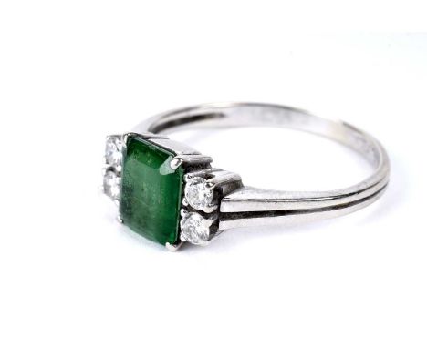 A green stone doublet and diamond ring, the step cut green-stone flanked by pairs of round brilliant-cut diamonds, in white g