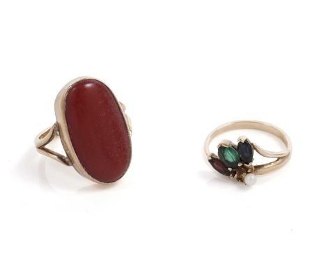 A coral cocktail ring, the collet set coral cabochon on bifurcated yellow gold shank, unmarked, size M, 5.2g gross; and a gar