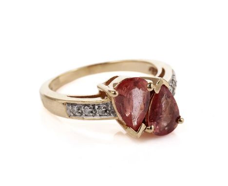 A fancy sapphire and diamond dress ring, possibly synthetic, the two faceted pear-shaped padparadscha-type sapphires above di