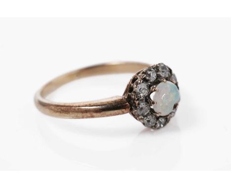 An opal and diamond cluster ring, in rose gold, stamped indistinctly, size M, 2.8g gross.