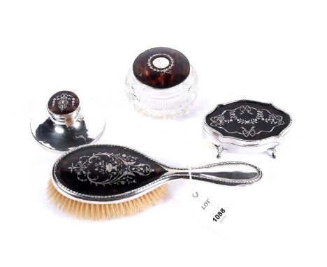 A collection of silver and tortoiseshell items, comprising: a hand brush, with urn and foliate silver inlaid; a cut-glass sil