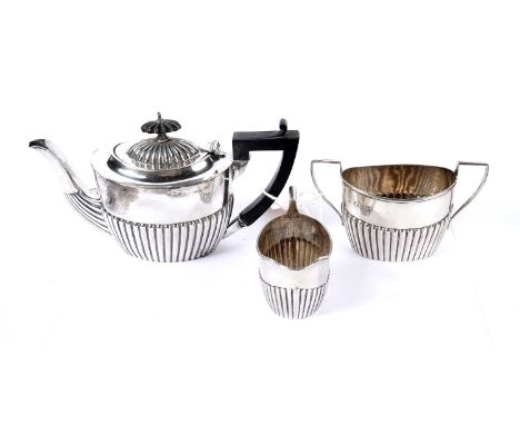 A three-piece silver bachelors tea service, Chester 1897, of half fluted form, 12.5oz gross.