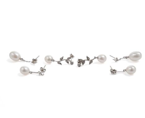 A pair of cultured pearl drop earrings, in white gold, stamped "9K", 23mm high, 2.8g gross; together with two pairs of silver
