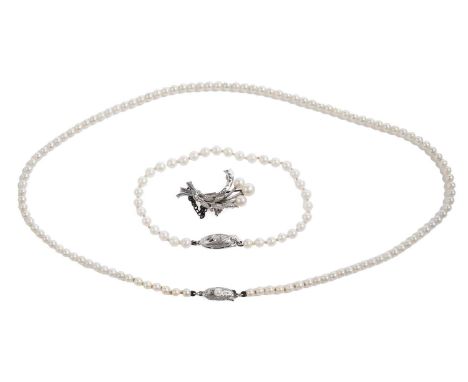 Mikimoto, Japan: a cultured pearl necklace, formed of a single strand of pearls, on pearl set silver clasp, with stamped make