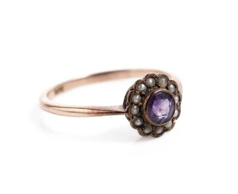 An Edwardian amethyst and seed pearl cluster ring, in rose gold, stamped "9ct", size P 1/2, 1.9g gross.