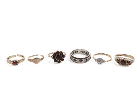 A selection of gold dress rings, including: a garnet cluster ring, in yellow gold, stamped "9ct", size M; a garnet and white 