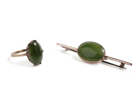 A nephrite jade cabochon cocktail ring, in yellow gold, stamped "9ct", size M 1/2, 2.3g gross; and a nephrite jade bar brooch