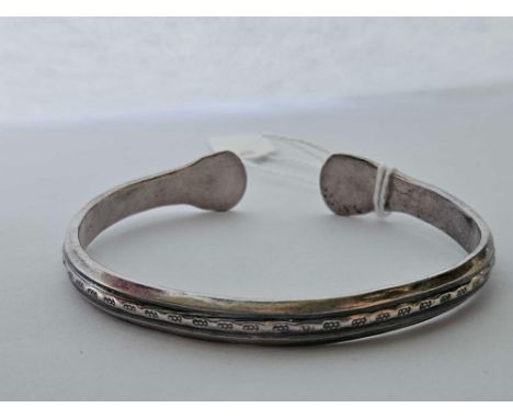 A silver torque bangle